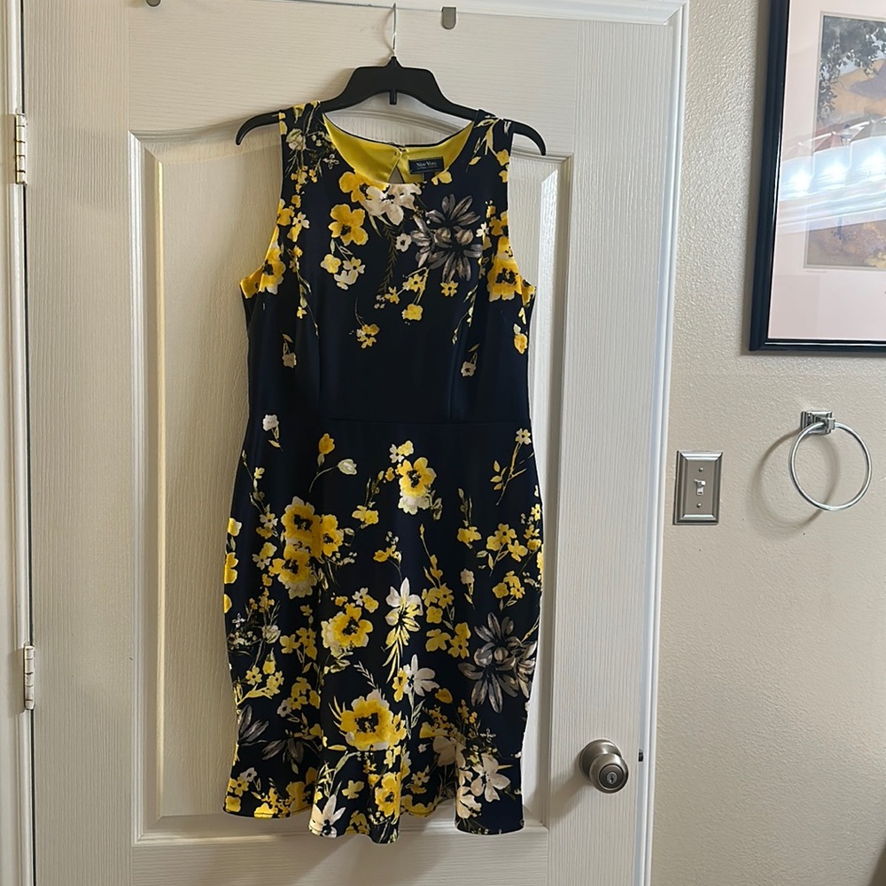 Black, Yellow and grey.  Has back cut out.  Ruffled bottom.